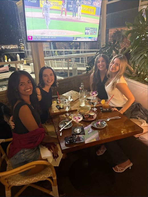 Four teammates at dinner on We Not Me Time