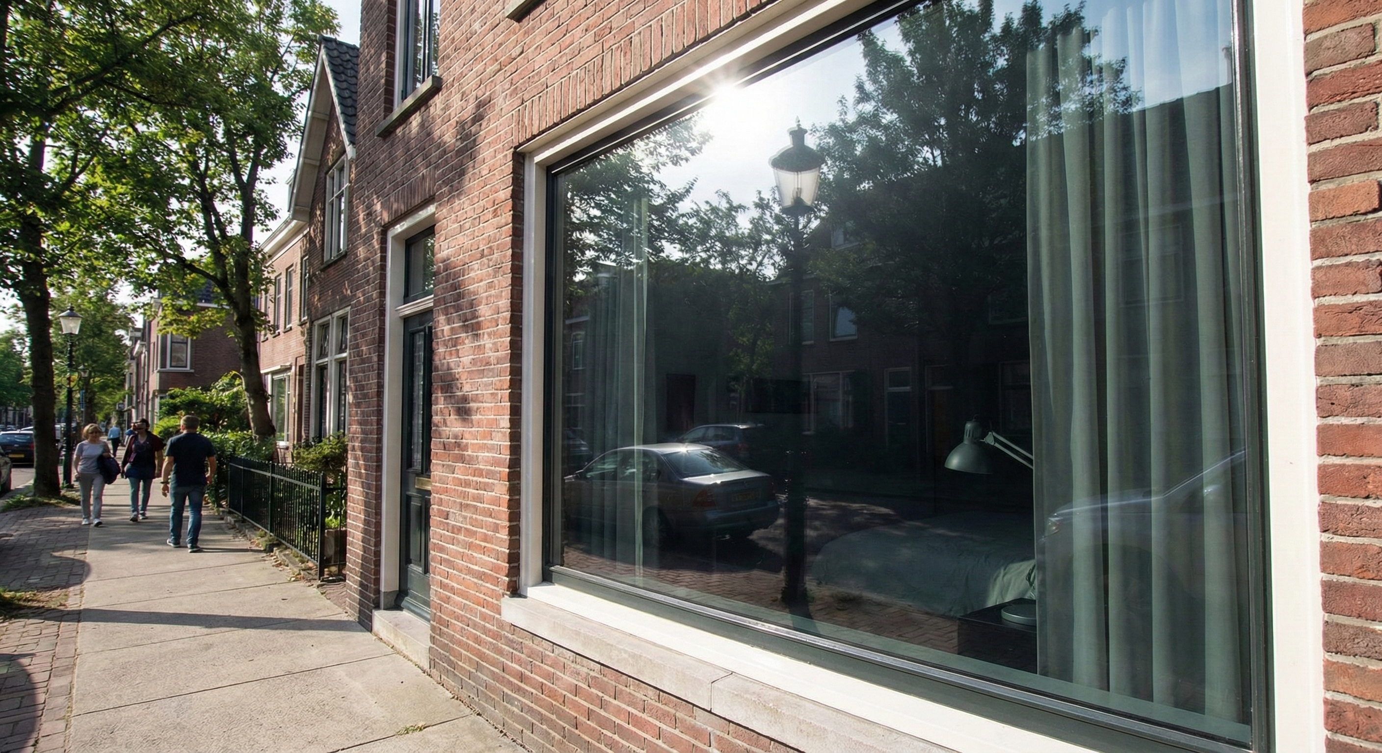 Reflective privacy window film showing daytime one-way mirror effect in a street-facing room.