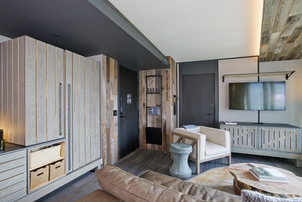 Boutique hotel suite with branded reclaimed-wood accent wall