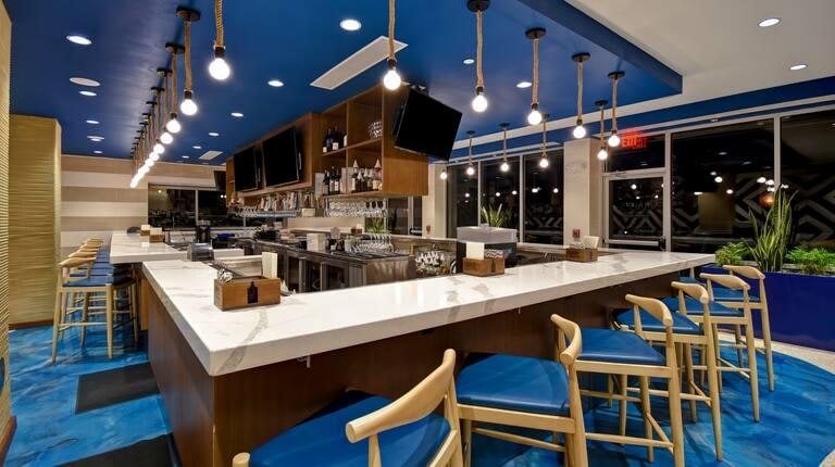 Hotel bar with DI-NOC walnut back wall and marble counter