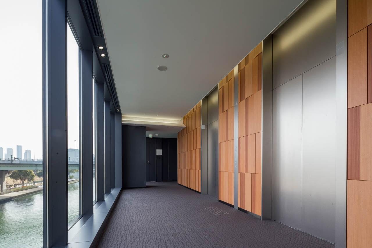 Hotel corridor with branded feature wall and view of the water