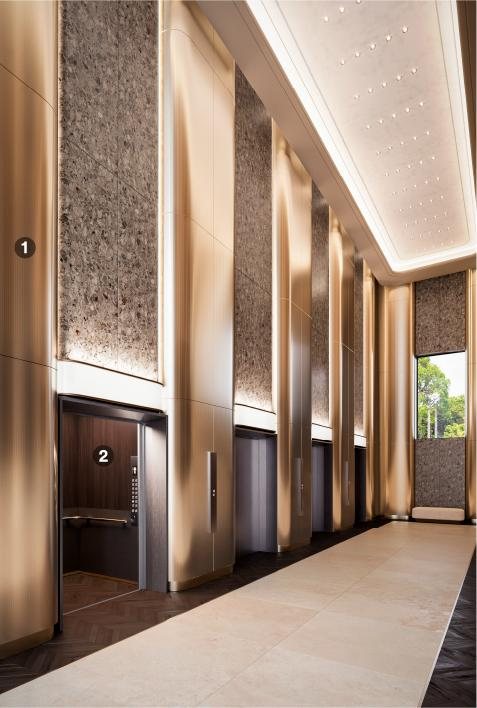 Luxury elevator bay with branded stone and metal graphics
