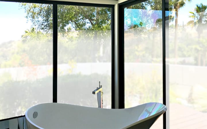 Frosted 3M privacy film on a townhome bathroom window in Plano, Texas