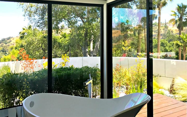 Clear townhome bathroom window in Plano, Texas before privacy film