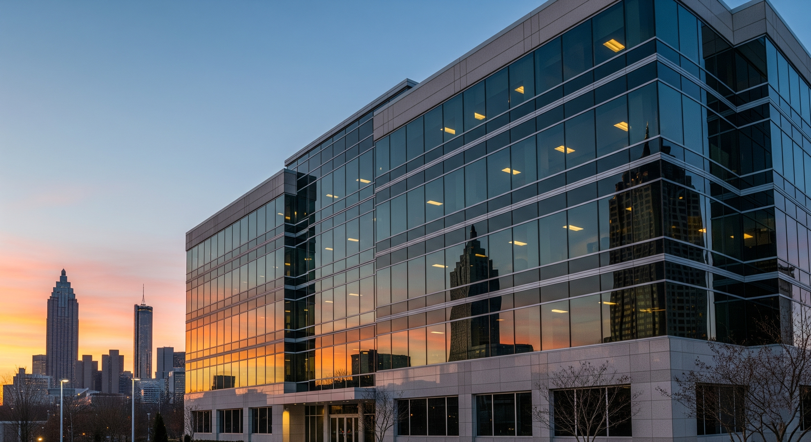 Atlanta office building with tinted windows reflecting city skyline, promoting commercial window tinting upgrade for energy savings and modern business comfort.
