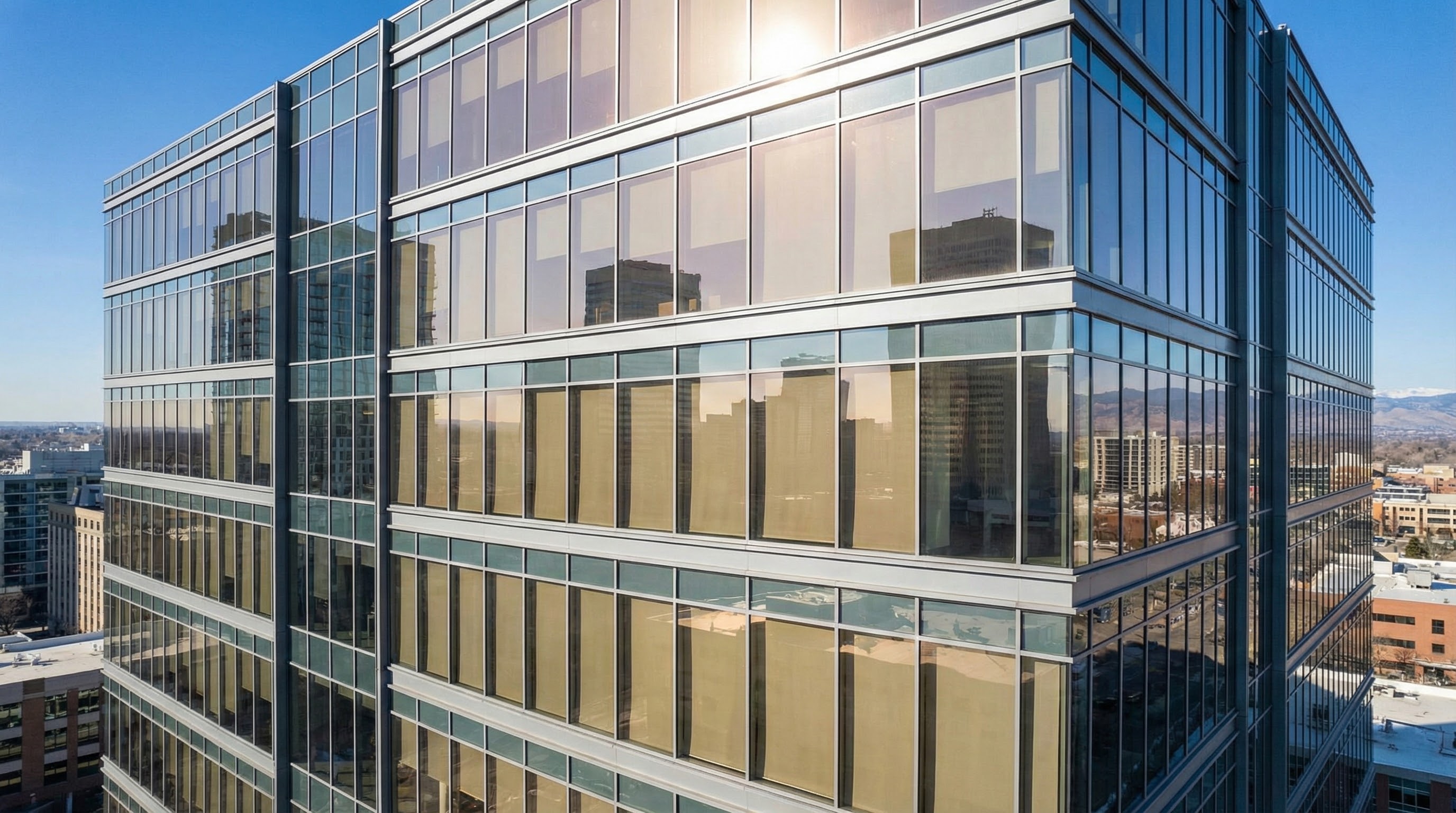 Denver office tower with solar control commercial window film in daylight.